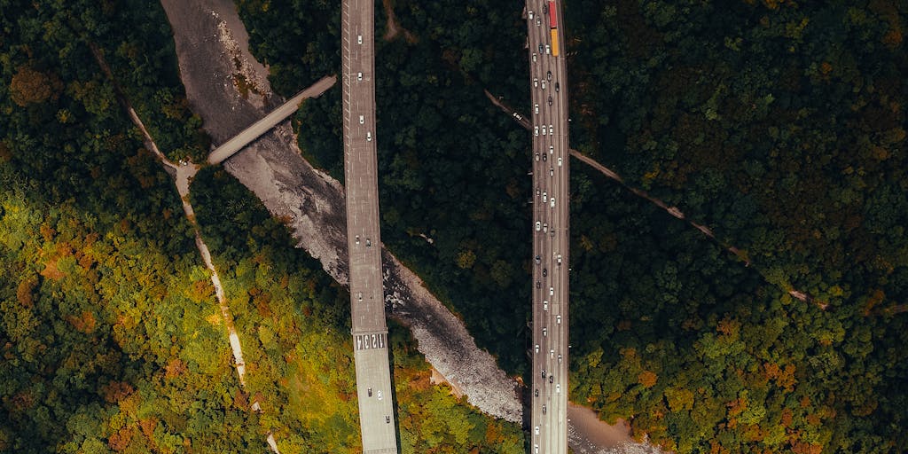 A conceptual image of a winding road disappearing into the distance. At the beginning of the road, a small toy car is placed, representing the child. The road is overlaid with a faint, transparent image of a tax form or a dollar sign, suggesting the path the refund should have taken. The overall tone should be slightly melancholic and reflective, emphasizing the feeling of the refund being lost or delayed. The lighting should be soft and diffused, creating a sense of distance and longing.