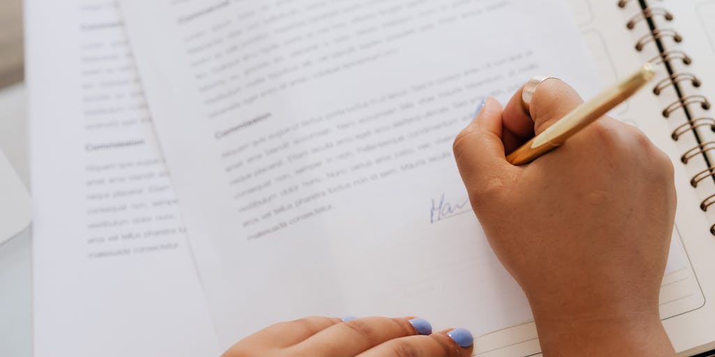 A close-up shot of a hand signing a document, with the focus on the pen tip and the signature forming. The background is intentionally blurred, but subtly reveals a cityscape skyline through a window, suggesting the 'city' aspect. The document itself has a small, discreet stamp or embossed seal indicating the 'state' (e.g., a state flag or outline). The lighting is dramatic, perhaps using a single light source to highlight the hand and pen, creating a sense of importance and finality.