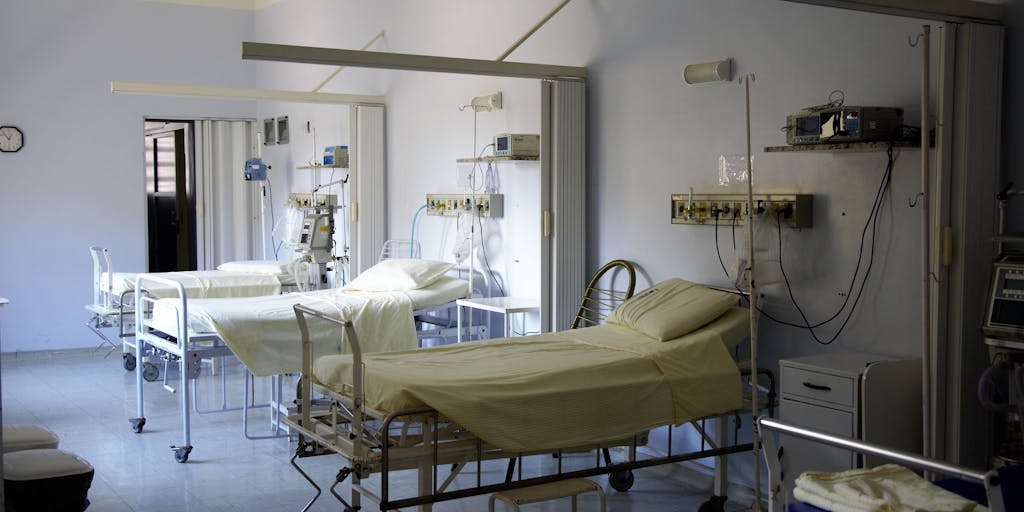 A split image showing two contrasting scenarios: on one side, a person in a hospital bed surrounded by medical equipment, and on the other side, the same person enjoying life outdoors, symbolizing the journey from injury to recovery and the impact on compensation.