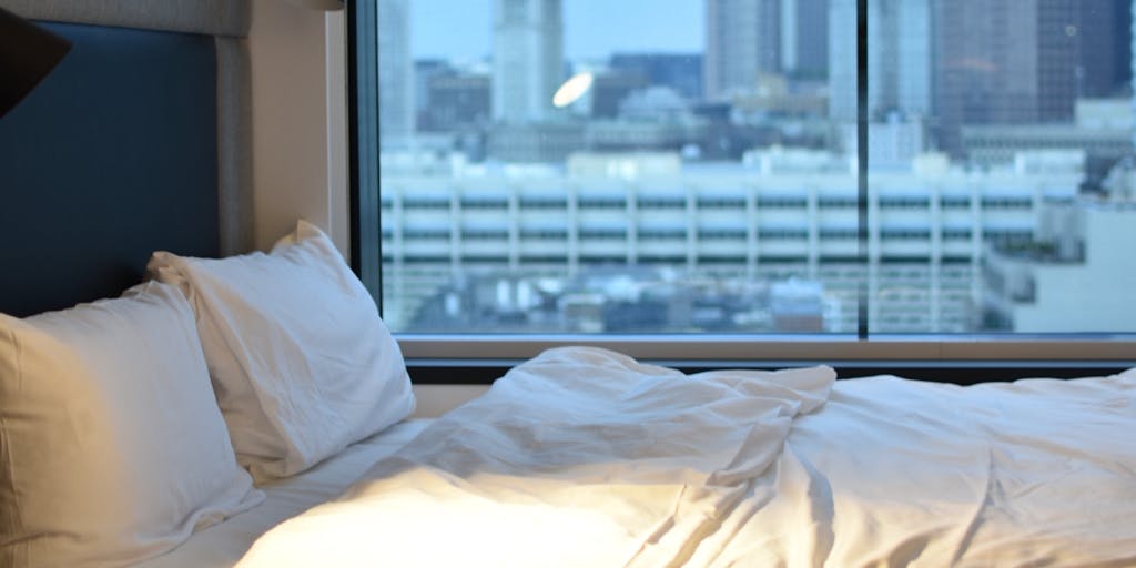 A luxurious hospital room with a view of a tropical beach, showcasing a patient receiving high-end medical treatment. The room is equipped with state-of-the-art medical technology and features a personal concierge service. The image captures the essence of combining medical care with a vacation-like atmosphere, emphasizing the appeal of medical tourism.