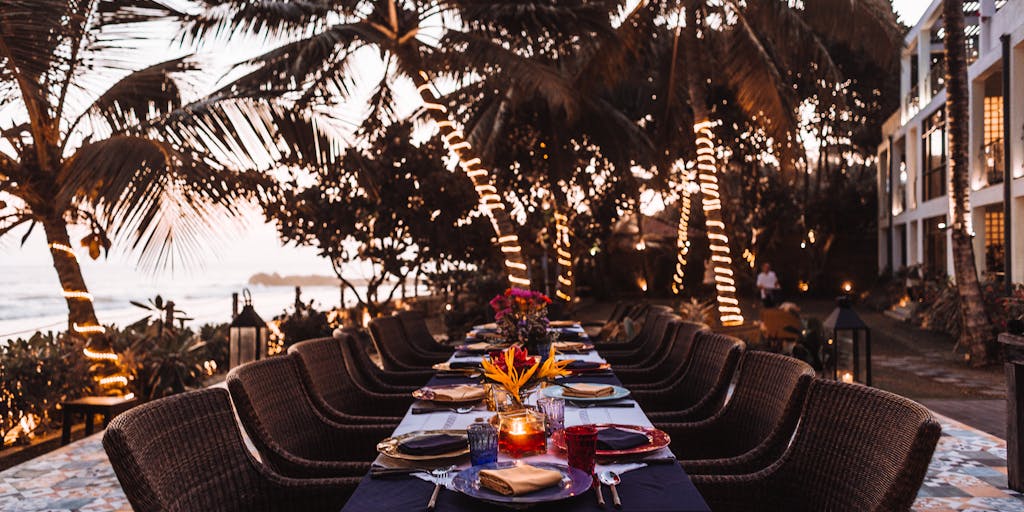 A candid shot of a diverse group of patients enjoying a post-treatment celebration at a luxury resort, complete with gourmet meals and wellness activities. The image conveys the idea of recovery and relaxation, emphasizing the benefits of integrating high-end medical services with leisure and legal advantages.