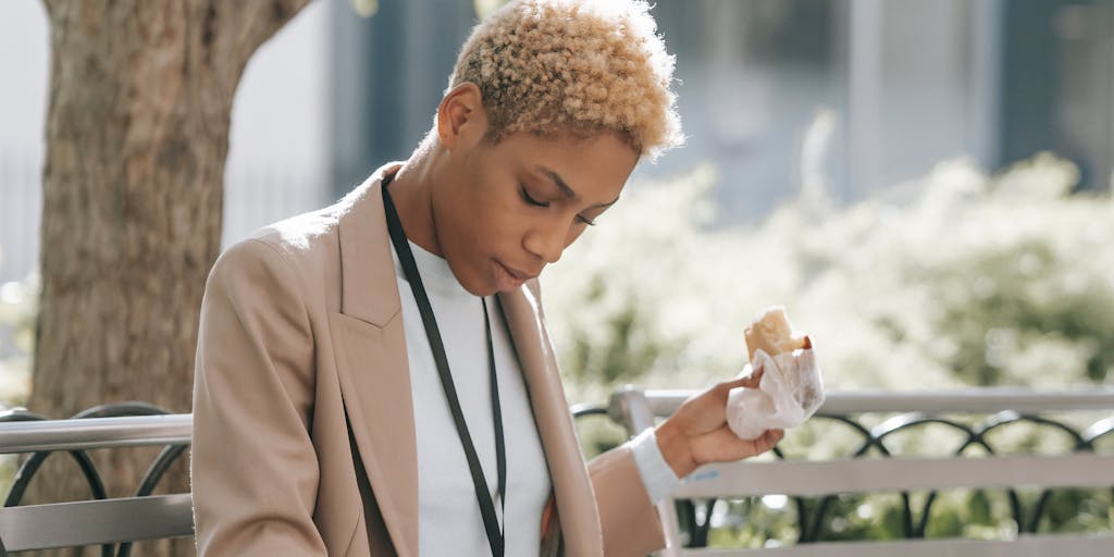 A split image showing two contrasting scenes: one side depicts a busy office environment with employees working hard, while the other side shows a serene park where people are relaxing, illustrating the balance between work and leisure over two business days.