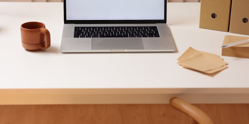 A visually appealing workspace featuring a laptop open to a data room interface, surrounded by organized folders, sticky notes, and a cup of coffee. The scene should convey a sense of productivity and organization, highlighting the importance of a well-structured data room.