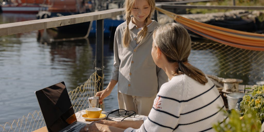 A creative composition featuring a laptop open to a business law website, placed on a wooden dock by the lake. The water ripples gently around the dock, and a pair of reading glasses and a notepad are nearby, suggesting a relaxed yet focused approach to legal matters for entrepreneurs.