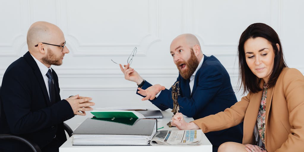 A humorous scene depicting a lawyer sitting at a cluttered desk surrounded by crumpled papers and failed advertisement drafts. The lawyer has a frustrated expression, and a thought bubble shows a light bulb moment with the words 'Keep it simple!' This image captures the chaos of poor advertising choices and the realization of what works.