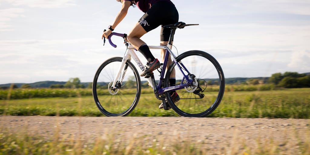 A split image showing two scenarios: on one side, a person nervously looking at a police car in their rearview mirror while driving; on the other side, the same person happily riding a bicycle with a helmet. This juxtaposition highlights the importance of alternative transportation methods to avoid legal trouble.