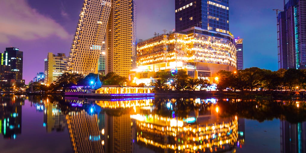 An artistic representation of a city skyline at dusk, with a large, illuminated sign that reads 'Bylaws' in neon lights. The foreground features silhouettes of people walking, symbolizing the impact of bylaws on community life.