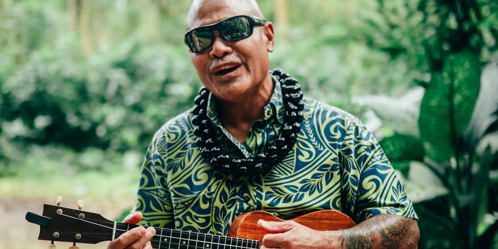 An artistic composition featuring a gavel resting on a Hawaiian lei, symbolizing the intersection of law and local culture. The background should be softly blurred to emphasize the gavel and lei, creating a striking visual metaphor for the legal profession in Hawaii.