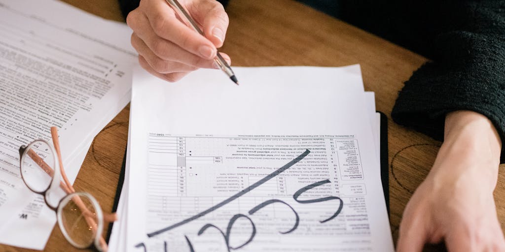 A close-up shot of a bank check with the First Horizon Routing Number prominently displayed. The check is placed on a wooden table with a stylish pen beside it, and soft natural light illuminates the scene, creating a warm and inviting atmosphere.