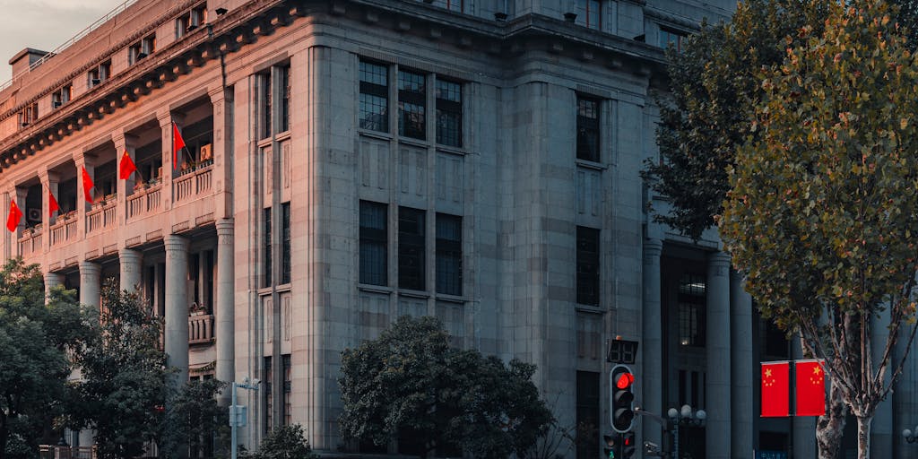 A creative representation of a bank building with the First Horizon logo and routing number artistically integrated into the architecture. The photo captures the building from a low angle, emphasizing its grandeur and stability, with a clear blue sky in the background.