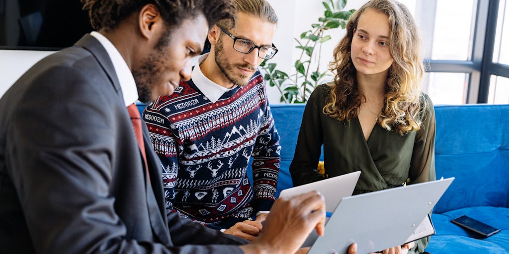 A diverse group of legal professionals engaged in a brainstorming session, with a large screen displaying AI-generated legal insights and predictions. The setting is modern and collaborative, emphasizing the role of AI in enhancing legal strategies and decision-making.