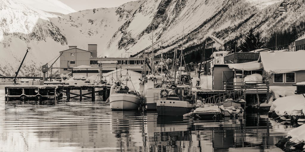 A creative split-image photo showing a lawyer in a suit on one side, and on the other side, a scenic view of a traditional Alaskan fishing village. This juxtaposition illustrates the contrast between the high-stakes legal world and the serene Alaskan lifestyle.