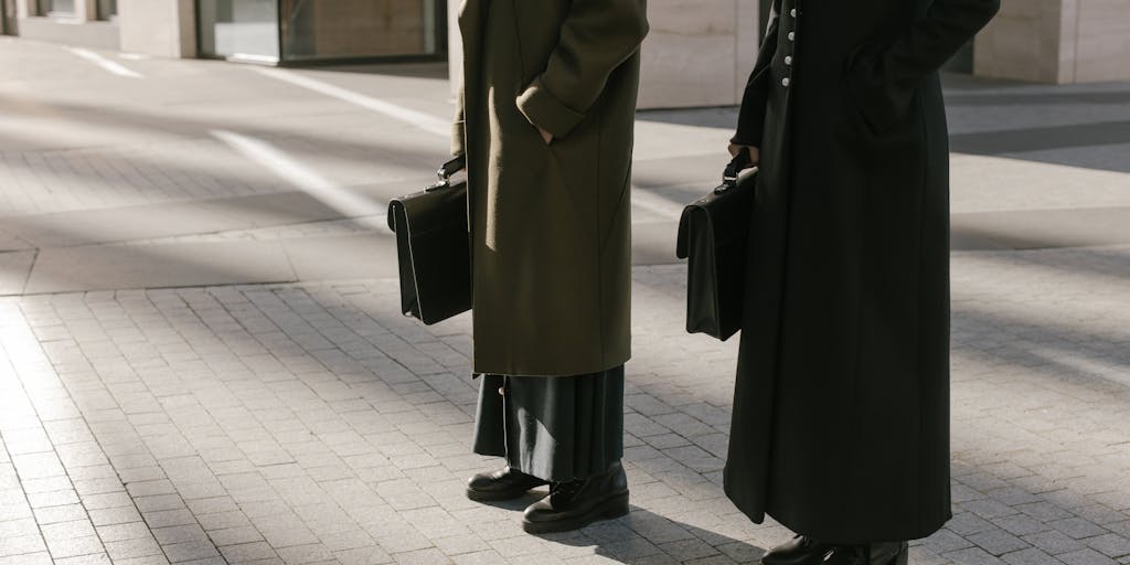 A candid moment of a lawyer in a tailored suit walking confidently through a bustling street in Banja Luka, with a briefcase in hand. The image should convey a sense of purpose and success, highlighting the dynamic nature of the legal profession.