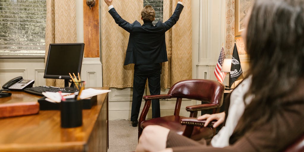 A candid shot of a high-profile lawyer in a tailored suit, engaged in a serious discussion with clients in a modern conference room. The lawyer is gesturing confidently, with legal documents and a laptop open on the table. The image conveys the intensity and dedication of top legal professionals in China, highlighting their role in high-stakes negotiations.