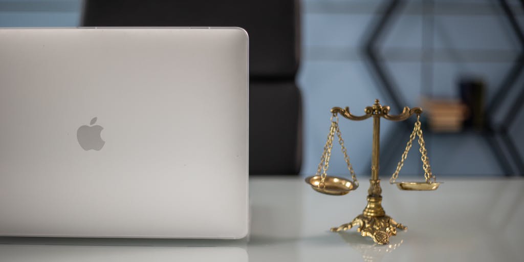 An artistic representation of the scales of justice, made from gold and silver, placed on a marble pedestal. Surrounding the scales are symbols of wealth, such as gold coins and luxury watches, illustrating the financial success of the highest paid lawyers in China. The background is softly blurred to keep the focus on the scales, creating a powerful visual metaphor.