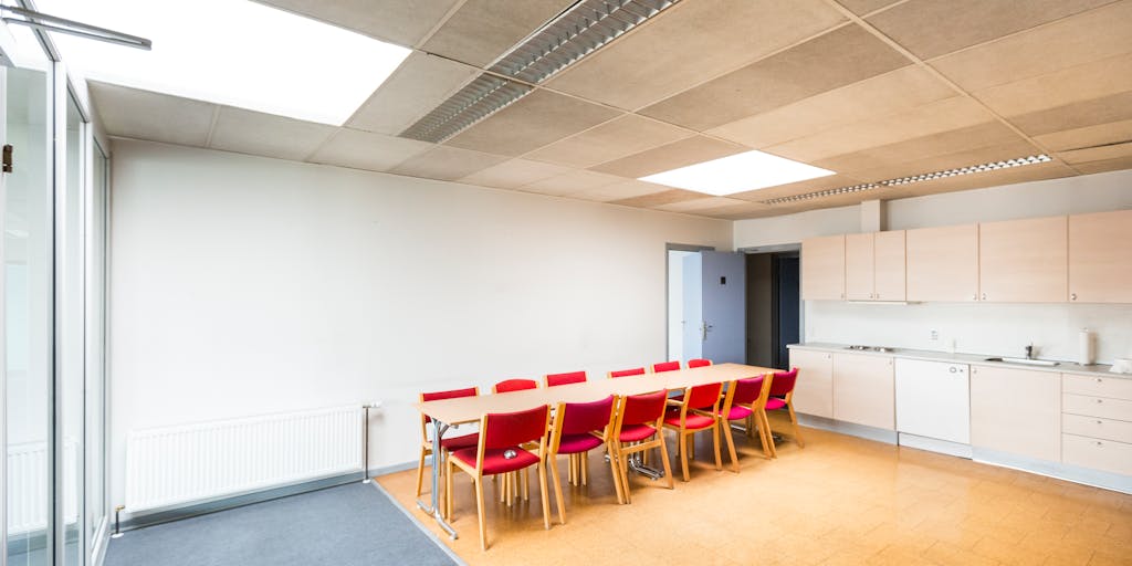 A candid moment captured in a luxurious conference room where a group of high-profile lawyers are engaged in a serious discussion. The room is adorned with modern decor and views of the ocean, showcasing the lifestyle of the highest-paid lawyers in Comoros.