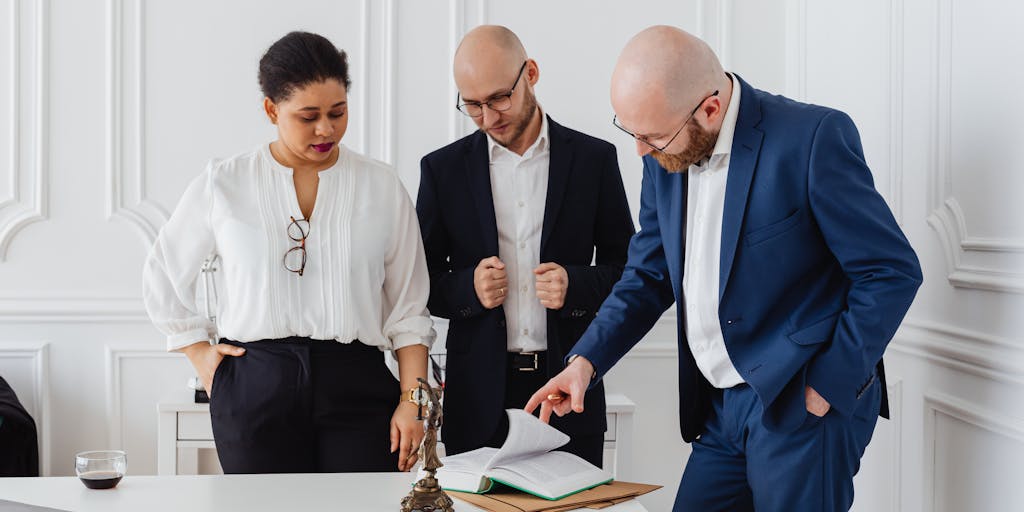 A powerful image of a group of top lawyers in a boardroom, engaged in a serious discussion. The room is filled with natural light, and the lawyers are diverse in gender and ethnicity, showcasing the modern legal landscape in the Czech Republic. The focus is on their expressions and body language, conveying determination and expertise.