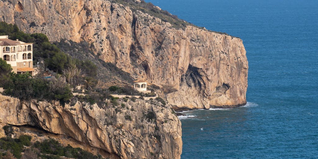 A powerful image of a lawyer standing on a cliff overlooking the ocean, with a briefcase in one hand and the other hand raised as if making a point. The dramatic waves crashing below symbolize the challenges faced in the legal profession.