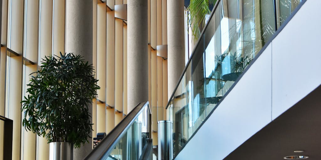 An artistic shot of a prestigious law firm’s entrance, featuring a modern building with glass doors and a sleek sign displaying the firm's name. The image should capture the essence of professionalism and success, appealing to those interested in the legal elite in Israel.