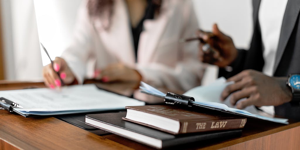 A candid moment capturing a group of top lawyers in Palau engaged in a lively discussion over a case, surrounded by law books and a map of Palau. The image conveys collaboration and the dynamic nature of legal work.