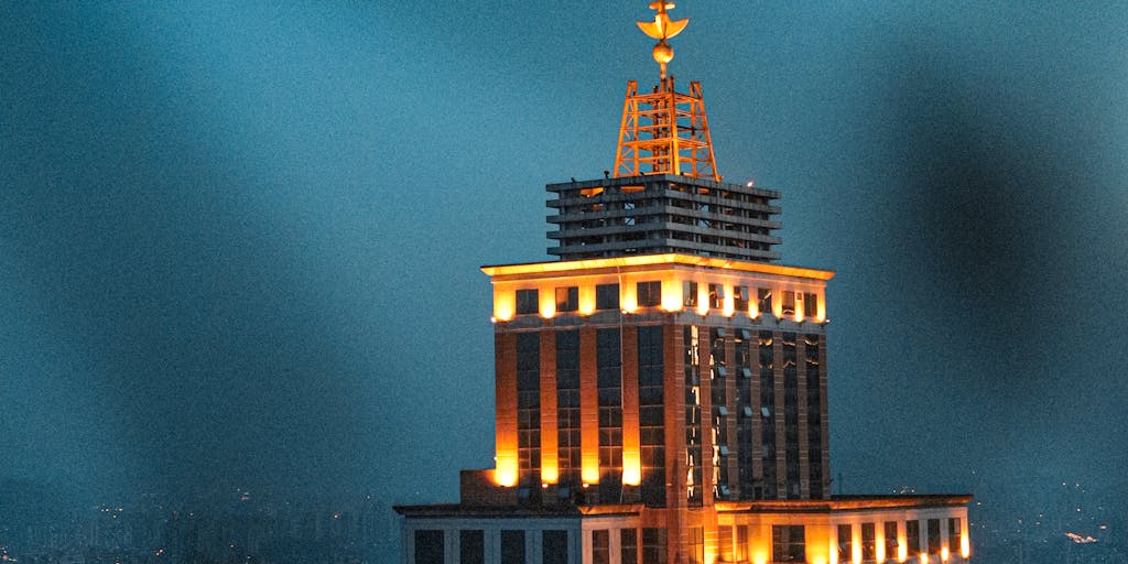 A dramatic portrait of a high-powered lawyer in a sleek, modern office overlooking the Moscow skyline. The lawyer is dressed in an elegant suit, confidently reviewing legal documents on a glass desk, with a cityscape view in the background. The lighting is warm and inviting, emphasizing the luxury and success associated with high-paid legal professionals.