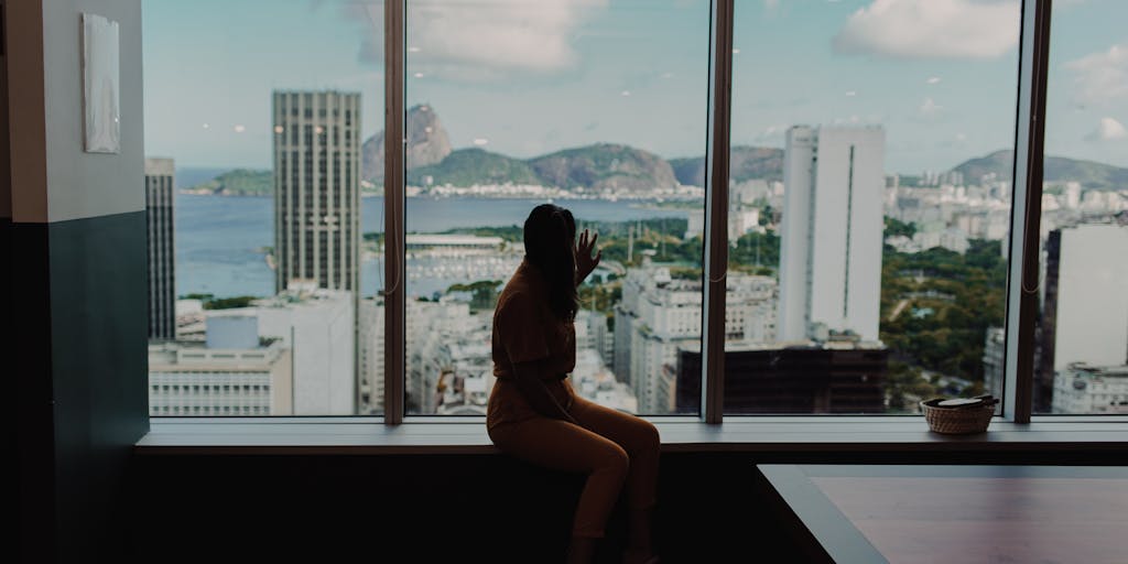 A dramatic portrait of a high-powered lawyer in a sleek office overlooking the ocean, with a backdrop of traditional Samoan architecture. The lawyer is dressed in a tailored suit, holding a briefcase, and gazing confidently out the window, symbolizing success and ambition in the legal field.