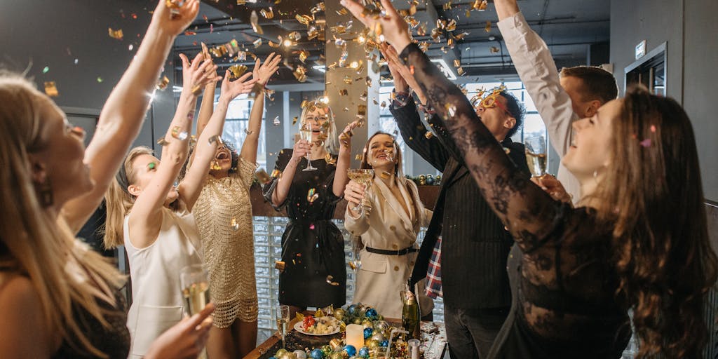 An elegant networking event scene featuring a group of well-dressed lawyers engaged in conversation, with glasses of champagne in hand. The setting is a chic venue with ambient lighting, showcasing the social aspect of being among the highest-paid lawyers in Serbia.