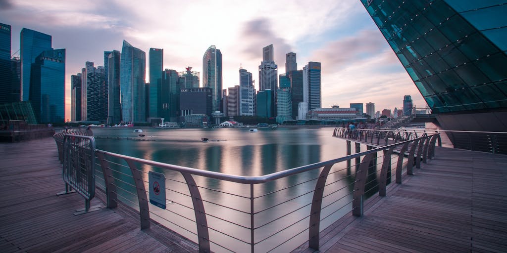 A high-angle shot of a luxurious office space with a panoramic view of Singapore's skyline. The office is adorned with legal books, a sleek desk, and a laptop open to a legal document. The image conveys the success and prestige associated with being one of the highest-paid lawyers in Singapore.