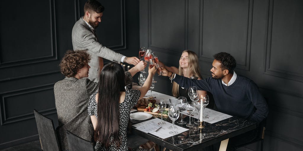 An overhead shot of a lavish dinner table set for a networking event, featuring high-profile lawyers discussing cases over fine dining. The table is adorned with elegant tableware, and the ambiance reflects a luxurious atmosphere, showcasing the social aspect of being a top lawyer in Uganda.