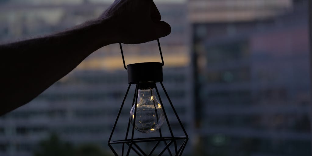 A conceptual image of a light bulb above a person's head, symbolizing the idea of creating a unique name. The background features a blurred image of a patent office or a legal building, emphasizing the connection between creativity and the legal process.