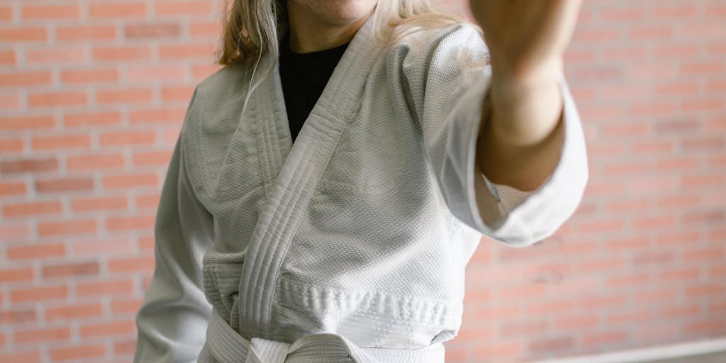 A series of photographs depicting a person training in a martial arts dojo, showcasing their intense focus and determination. The images capture the sweat and effort involved in the training process, symbolizing the mental and physical inuring to challenges.