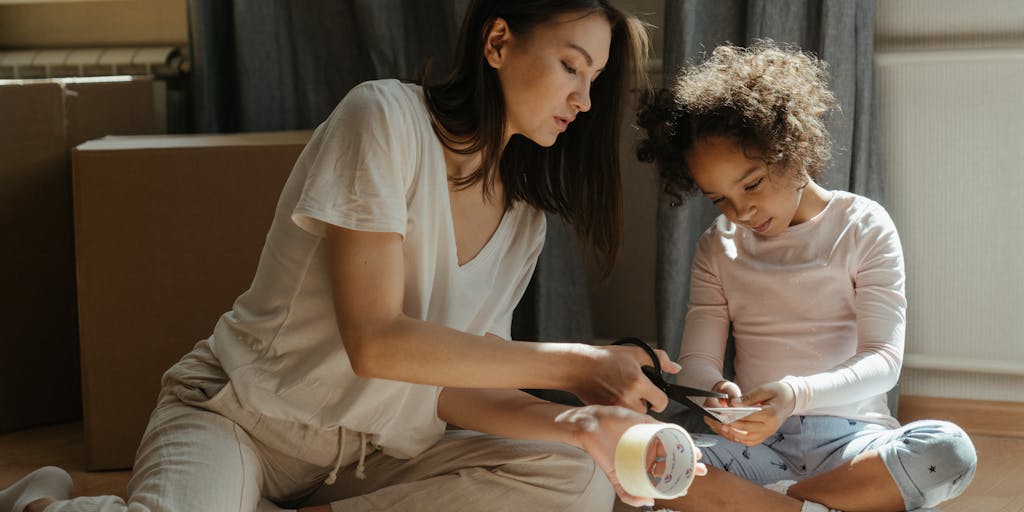 A creative flat lay of various items representing child support: a piggy bank, a school book, a toy, and a receipt. This arrangement visually narrates the different aspects of a child's needs that child support helps to cover.