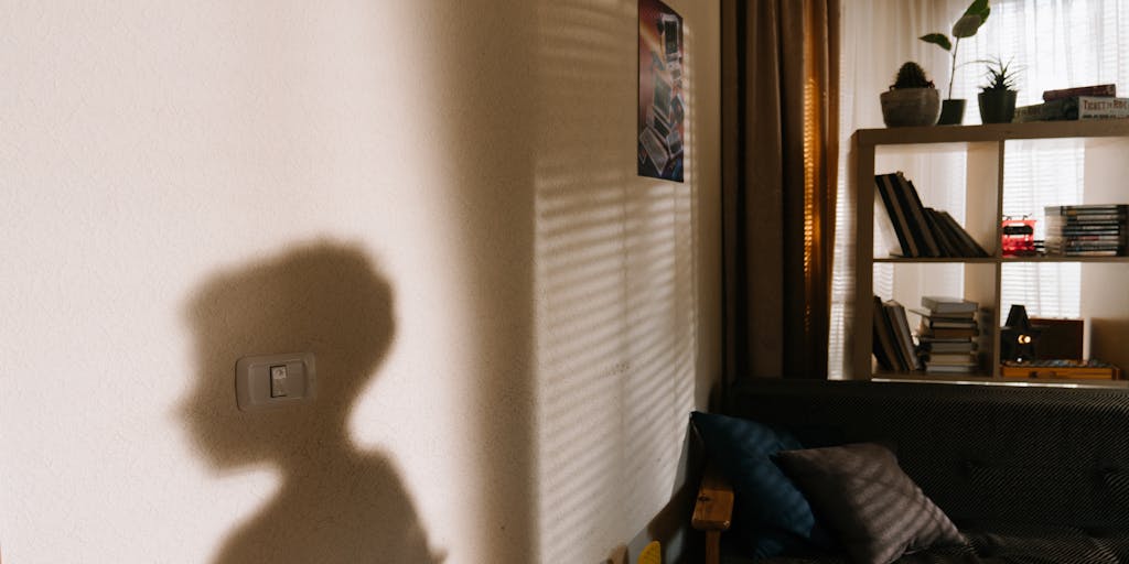 A split image showing two contrasting scenes: on one side, a child happily playing in a well-furnished room filled with toys and books, and on the other side, a parent reviewing bills and financial documents at a kitchen table. This visual representation highlights how child support contributes to a child's well-being and the financial responsibilities of the parent.