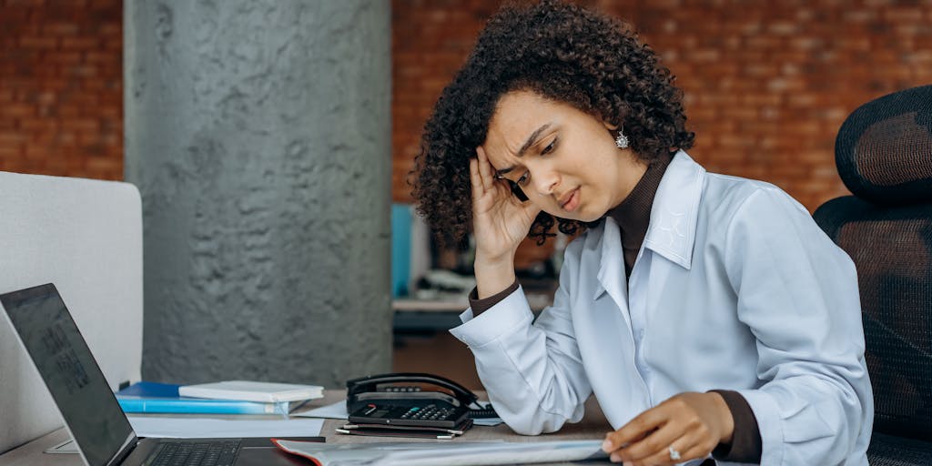 An image of a parent sitting at a desk, looking stressed while reviewing tax documents. The room is dimly lit, with a clock on the wall showing the time passing, symbolizing the waiting period for child support recovery. A child's toy is visible in the corner, representing the impact of the situation on family life.