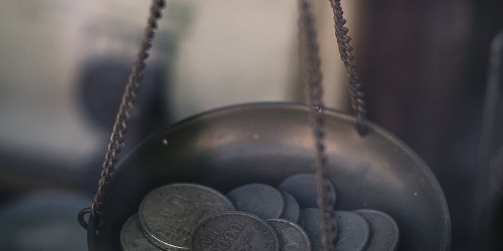 An artistic representation of a scale balancing a stack of money on one side and a child's toy on the other. This symbolizes the balance between financial obligations and the well-being of the child, emphasizing the importance of child support.