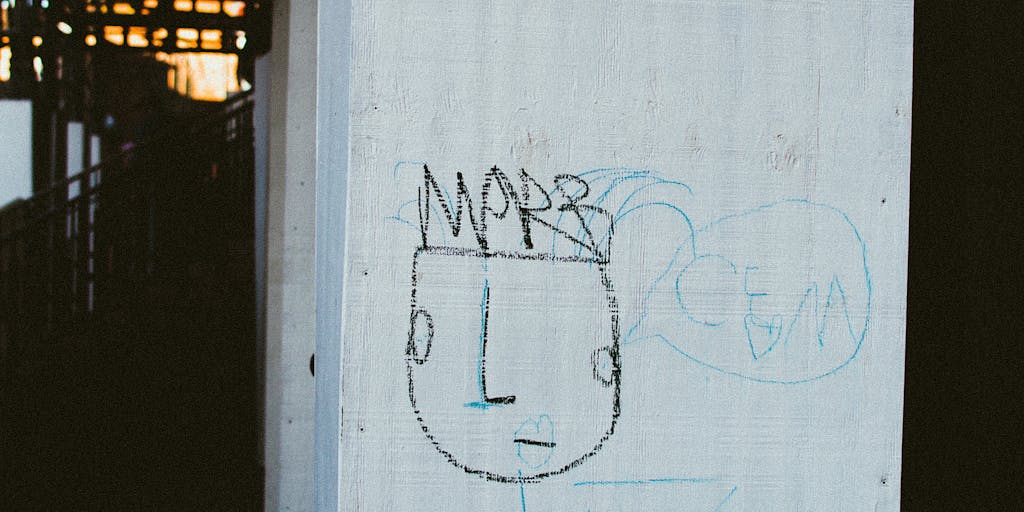 A close-up shot of an empty wallet lying on a table, with a child's drawing in the background. The drawing symbolizes the emotional aspect of child support, highlighting the contrast between financial struggles and parental love.