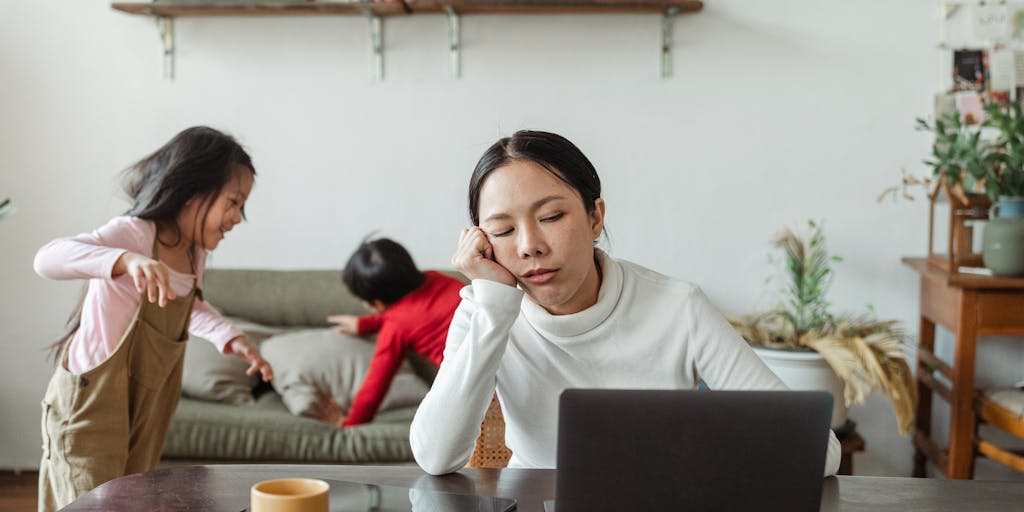 A split image showing a parent looking stressed while reviewing bills on one side, and a child playing happily on the other side. The contrast highlights the financial burden of child support versus the joy of parenting. The background can include tax forms and a calculator to emphasize the financial aspect.