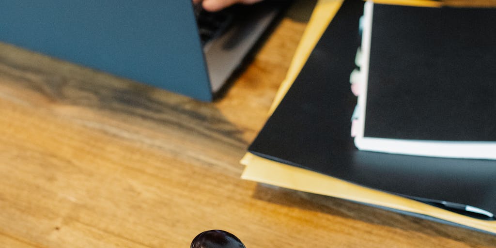 A close-up shot of a gavel resting on a stack of legal documents, with a blurred background of a courtroom. The documents should have visible headings like 'Child Support Agreement' and 'Court Order', symbolizing the legal aspect of child support in Texas.