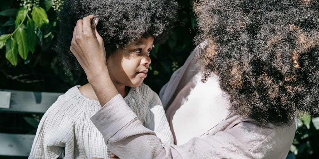 A poignant image of a parent and child sitting on a park bench, with the parent looking contemplative and the child playing with a toy. This captures the emotional aspect of child support and the impact on family dynamics.