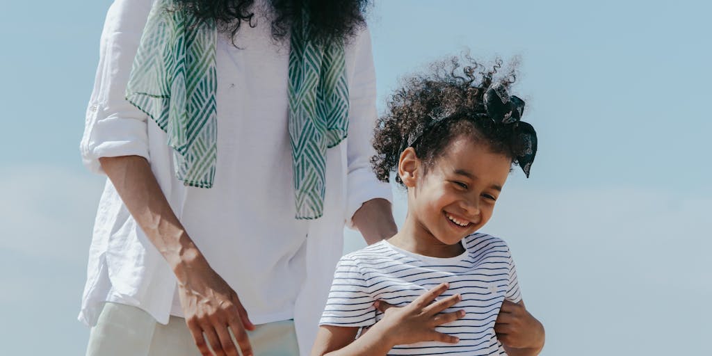 A candid photo of a parent and child engaging in a fun activity, like playing in a park or cooking together, with a subtle overlay of text showing the child support calculation. This represents the positive impact of financial support on quality time.