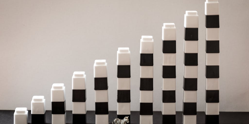 An artistic representation of a scale balancing a stack of money on one side and a child's toy on the other. This symbolizes the balance between financial obligations and the well-being of a child, emphasizing the importance of child support.