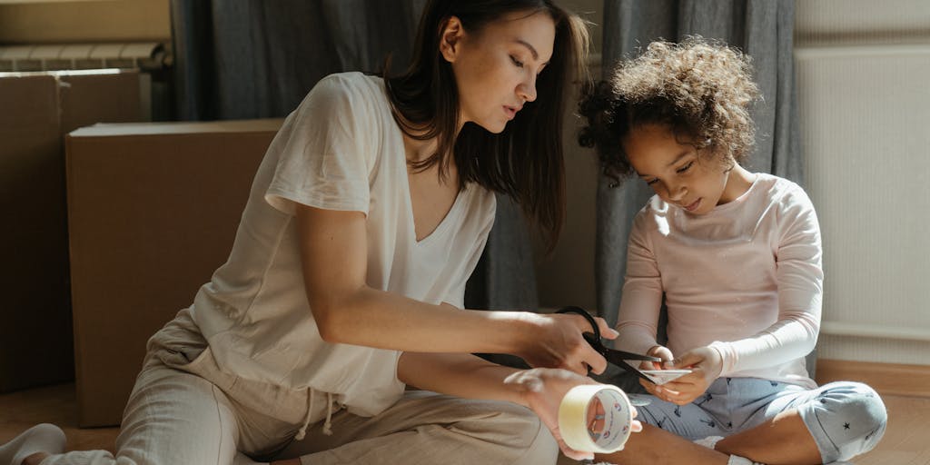 A creative flat lay of various items representing child support: a broken piggy bank, a toy, a legal document, and a map. The items are arranged in a way that tells a story about the financial and emotional aspects of child support, emphasizing the states that do not enforce it.