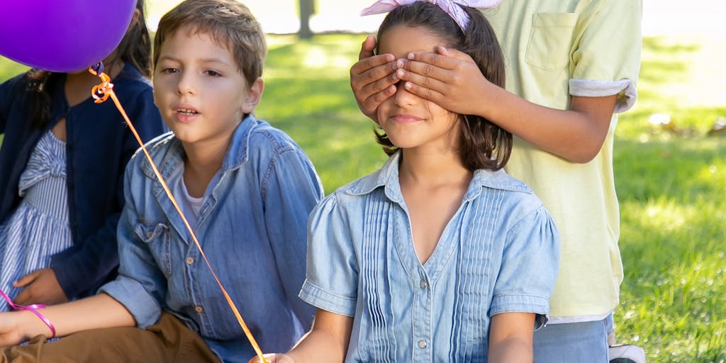 A family portrait taken in a park, where the child is holding a balloon that says '18' while the parents are smiling, capturing the essence of celebration and the bittersweet moment of reaching adulthood and the end of child support.