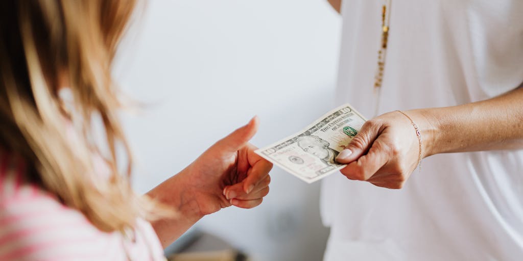 A split image showing two contrasting lifestyles: on one side, a parent happily engaging in activities with three children, such as playing in a park or cooking together; on the other side, a stack of bills and a calculator, symbolizing the financial responsibilities of child support. This visual juxtaposition highlights the balance between emotional and financial aspects of parenting.