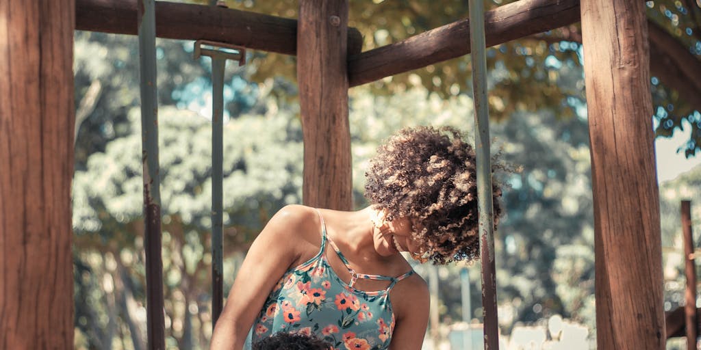 A close-up shot of a hand holding a child support payment check, with a blurred background of a playground. This image captures the essence of financial support directly contributing to a child's happiness and well-being.