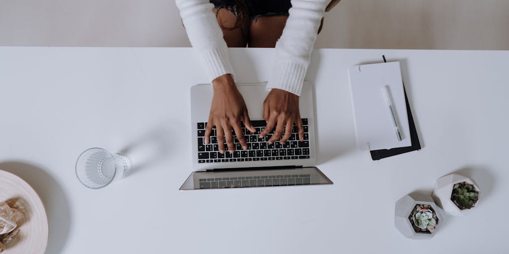 An overhead shot of a desk cluttered with notes, coffee cups, and a smartphone displaying the Instantly.ai app. The scene should convey a sense of productivity and creativity, with a notepad open to a page filled with brainstorming ideas related to AI.