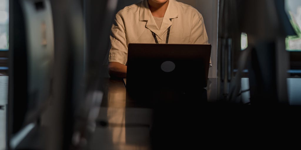 A split image showing two contrasting scenarios: on one side, a frustrated business person surrounded by piles of paperwork, and on the other side, the same person looking relieved and happy while using Datanyze on a laptop. This visual metaphor highlights the efficiency and ease of using data analytics.