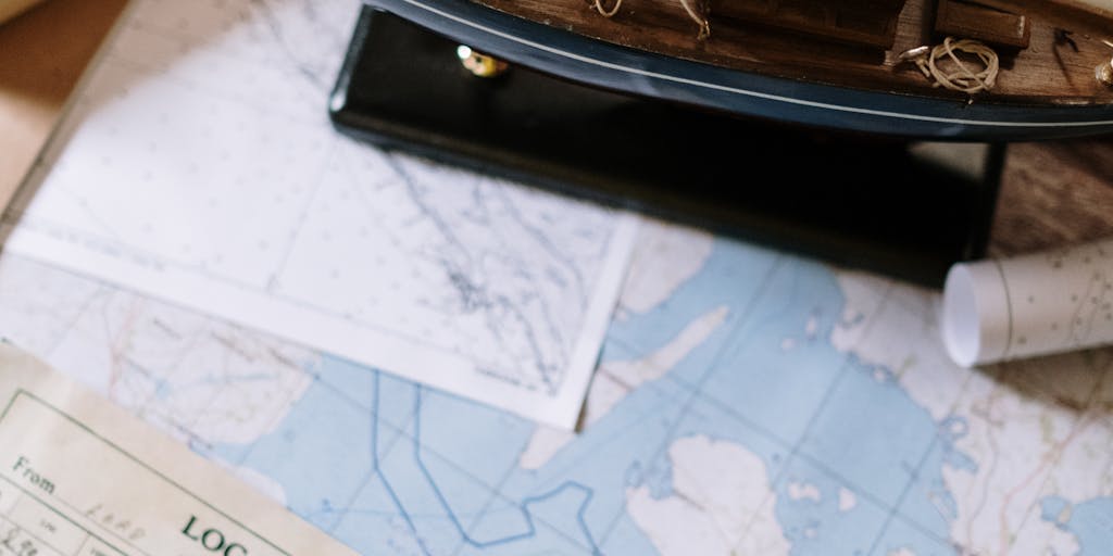 A close-up shot of a vintage Apollo spacecraft model placed on a wooden desk, surrounded by open books and scattered notes. The warm lighting creates a cozy study atmosphere, emphasizing the theme of exploration and knowledge.