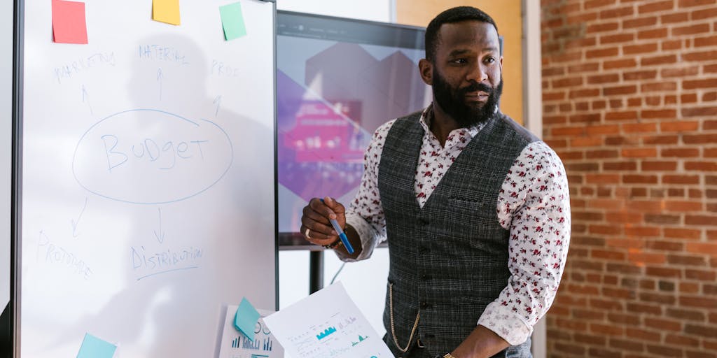 A dynamic image of a business team in a meeting room, discussing Smartlead pricing strategies. The focus should be on a whiteboard filled with pricing models and graphs, capturing the energy and collaboration of the team.