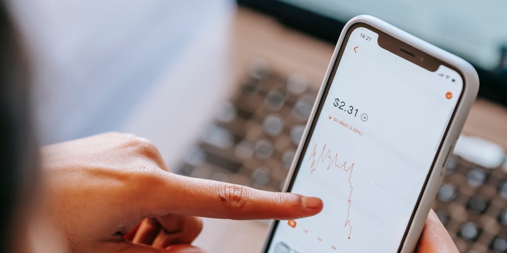 A close-up shot of a smartphone displaying a vibrant app interface that shows dynamic pricing updates for various AI services. The background features a blurred office setting, symbolizing a tech-savvy environment. The screen should have colorful graphs and numbers to represent instant pricing changes.